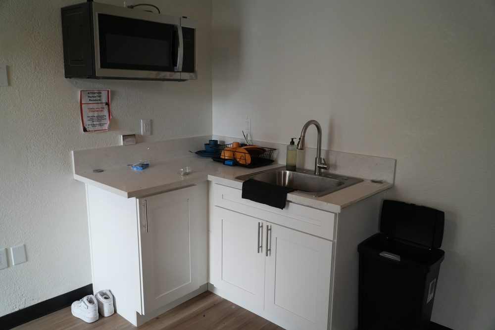 Private kitchenette in a HarborTAY unit with sink, cabinets and microwave